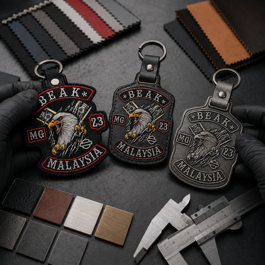 Custom motorcycle club keychain samples with an authorized logo being compared before production approval.
