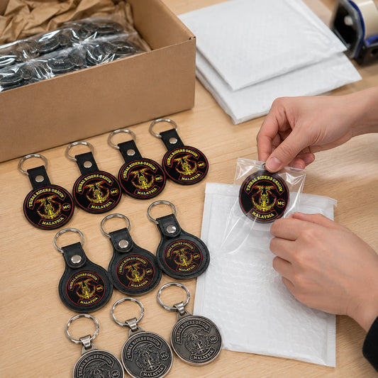 Finished motorcycle club keychains with an authorized logo packed for worldwide club and chapter shipping.