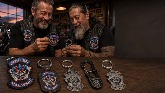 Motorcycle club members reviewing custom textile, leather, metal and silver keychains with an authorized club logo.