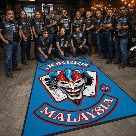 Motorcycle club members gather around a custom anniversary event rug.