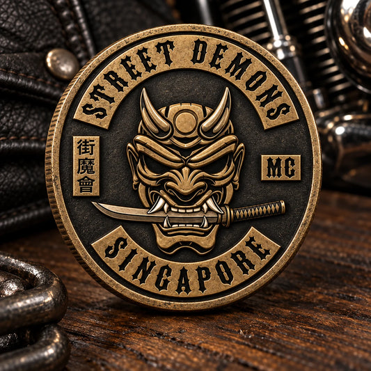 Two-dimensional die-struck motorcycle club challenge coin with raised metal detail.