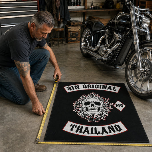 A rider measures garage floor space for a custom motorcycle club rug.