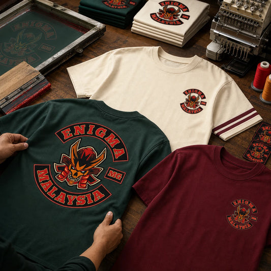 Enigma MG Malaysia member and officer short-sleeve club shirt variations arranged in a motorcycle apparel print workshop.