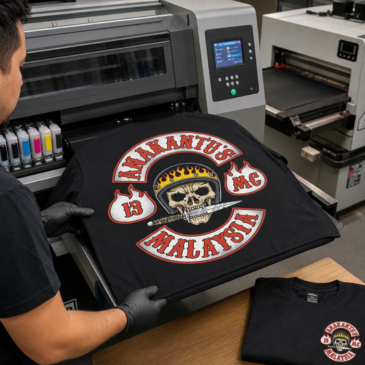Anakantu's MC Malaysia full-color back logo being printed directly onto a black motorcycle club T-shirt with a digital DTG printer.