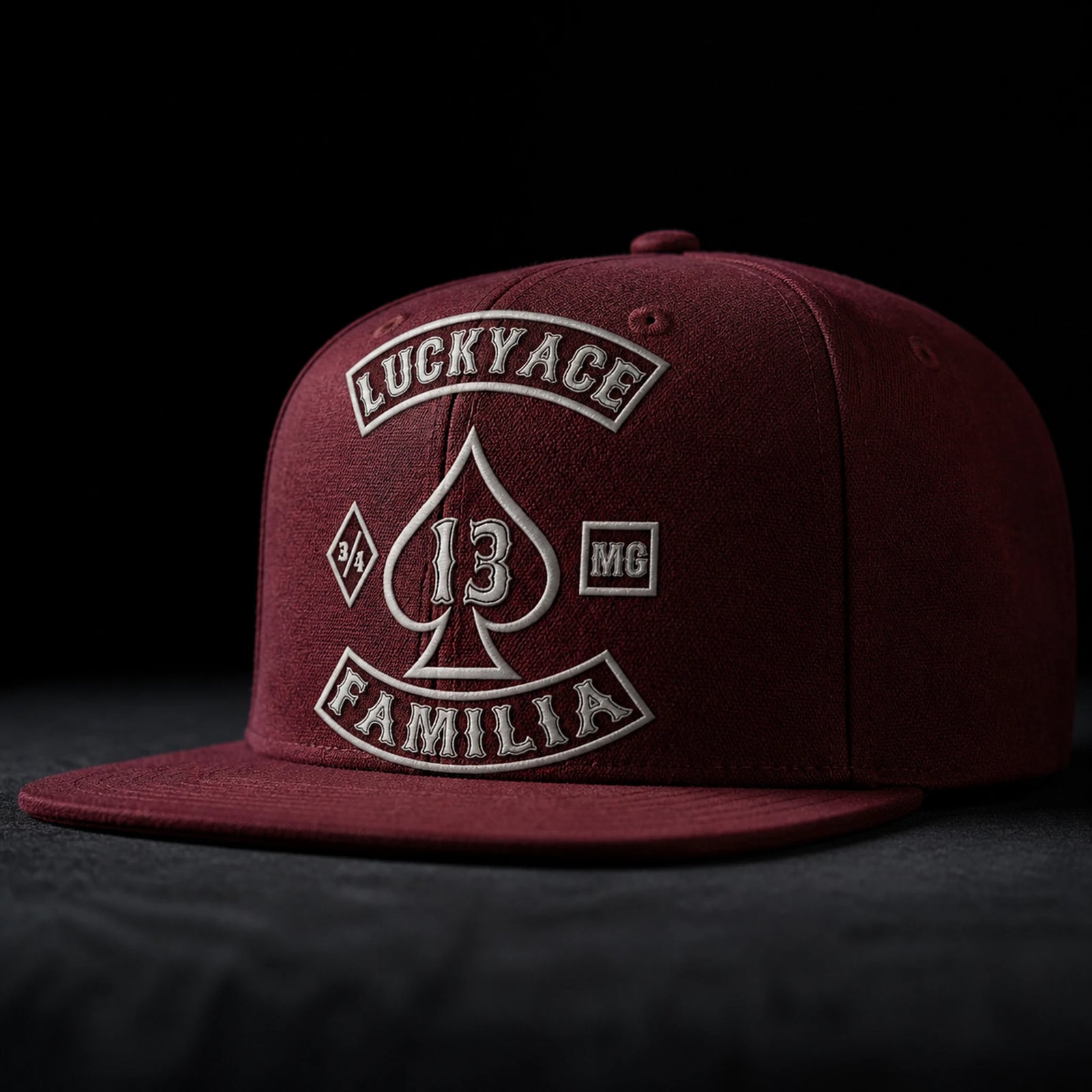 A maroon motorcycle club flat-brim cap displays dense texture from an acrylic-wool blend.