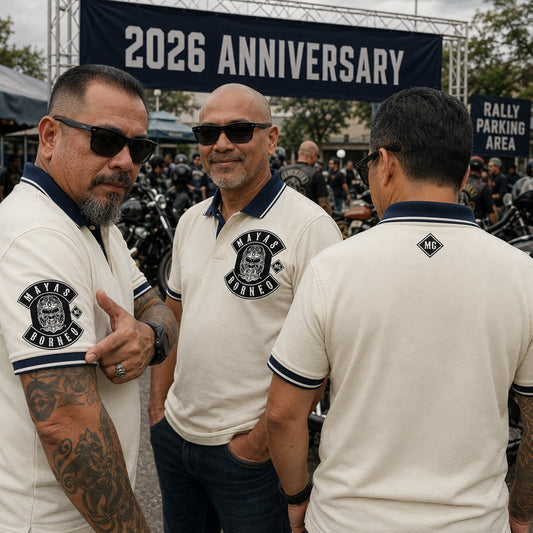 Mayas members at an anniversary rally wear cream and navy polos with sleeve embroidery, an upper back mark, and a 2026 ANNIVERSARY detail.