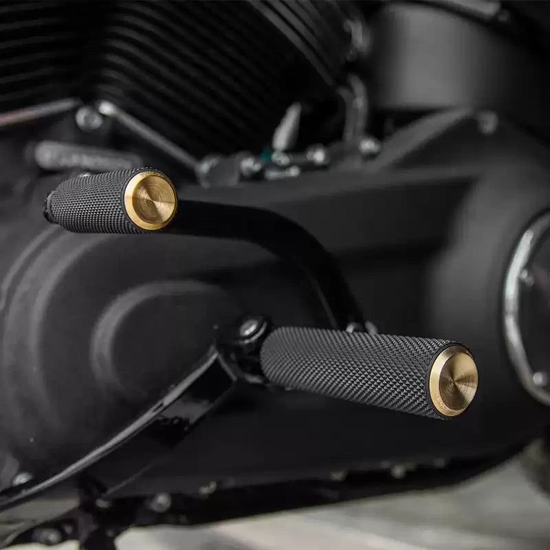 Arlen Ness brass knurled foot pegs on harley