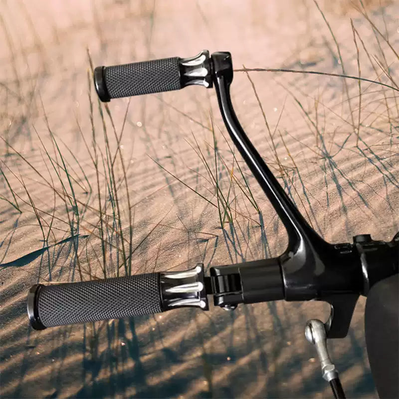 Pair of black Arlen Ness Fusion foot pegs installed on a Harley motorcycle