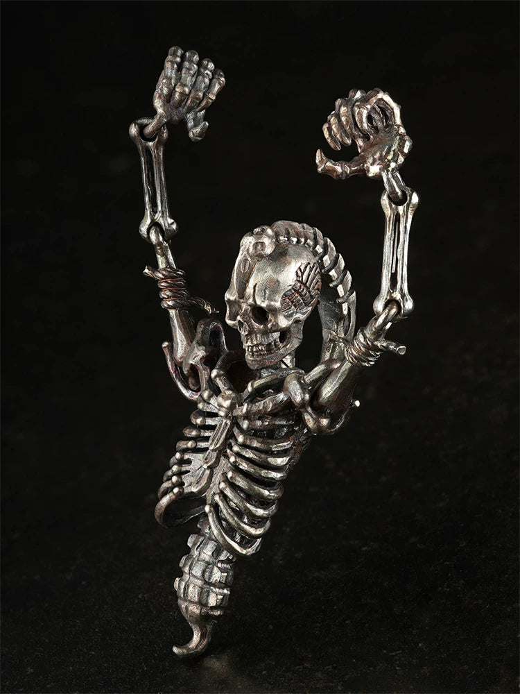 Articulated skeleton pendant with raised arms