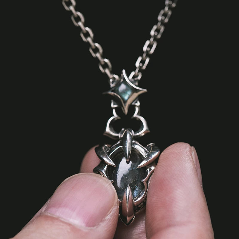 Handheld view showing the scale and stone detail of the biker pendant