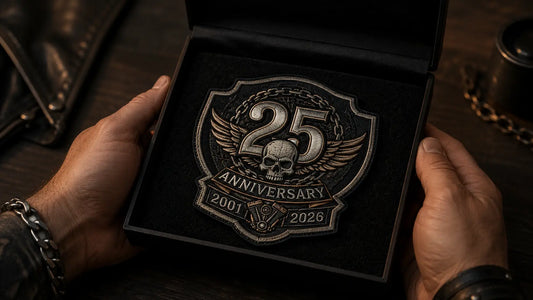 Biker anniversary patch showing 2026 inside a black presentation box with two hands and a clean cinematic clubhouse background