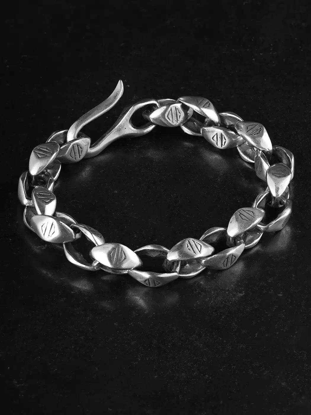 handcrafted silver biker link bracelet on black background