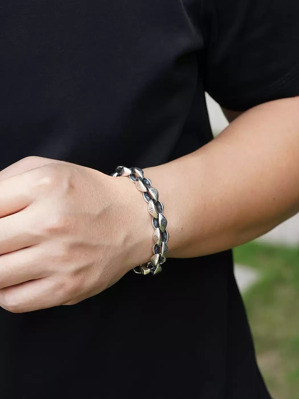 antique finish silver hook bracelet on a man's wrist
