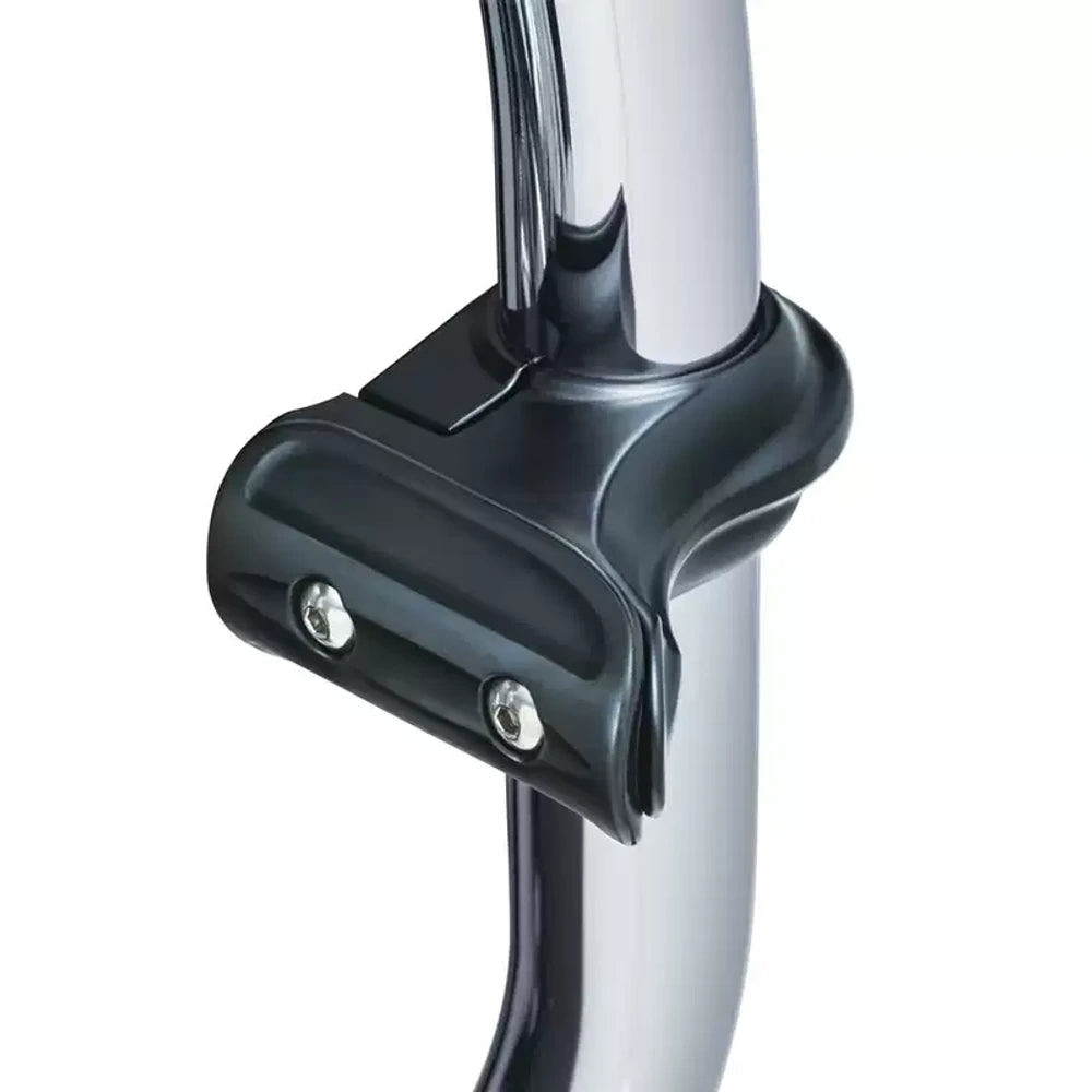 Close-up of black highway foot peg clamp installed on a chrome crash bar