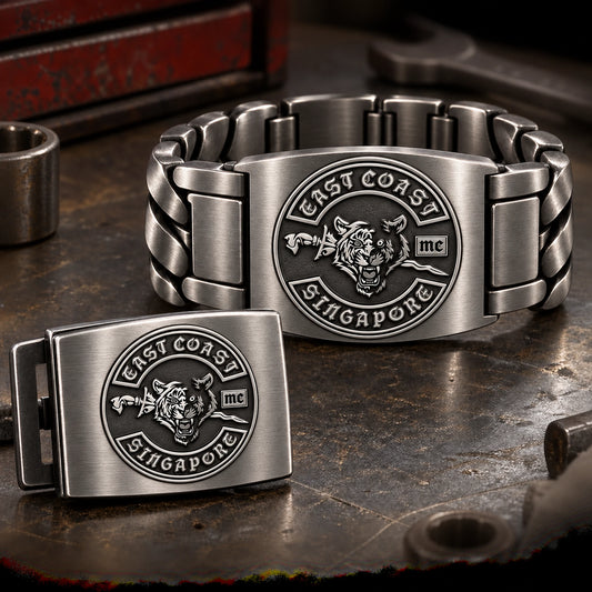 Brushed-finish motorcycle club metal pieces with directional texture and solid logo relief.