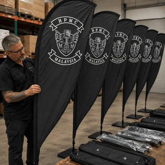 Bulk Club Orders: custom motorcycle club feather flag shown in warehouse crew checking a large club order before dispatch.