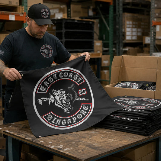 Motorcycle club members use a custom rectangular flag for bulk club orders in a realistic American V-twin setting.