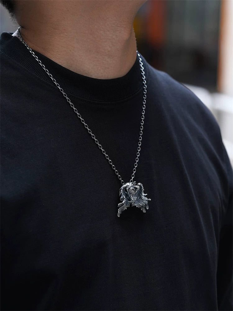 Chained winged Andromeda silver pendant worn at an angle