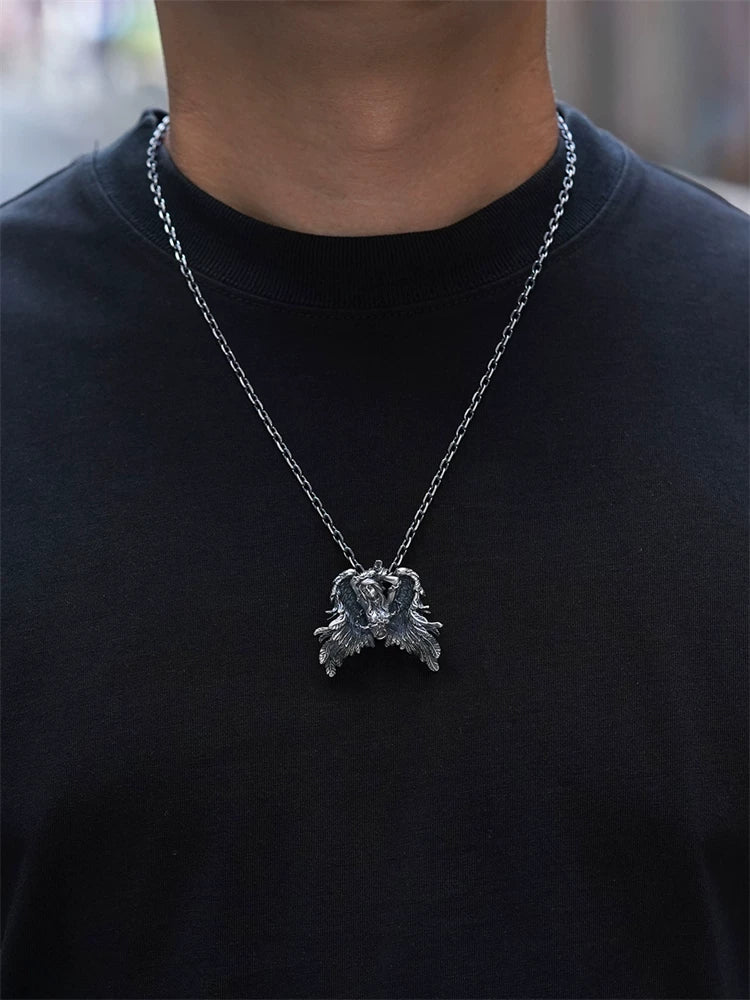 Chained winged Andromeda sterling silver pendant worn for scale
