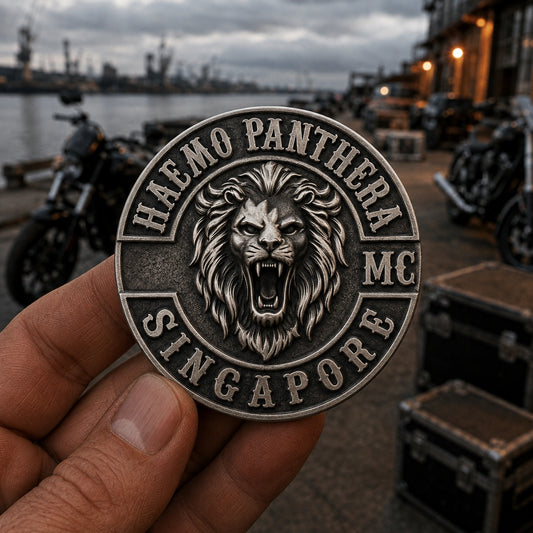 One-piece antique silver HAEMO PANTHERA chapter pin with a deeply sculpted lion emblem held at a harbor meeting point.