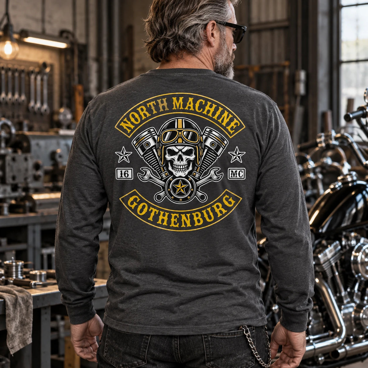 Charcoal motorcycle club long-sleeve shirt shown in a cool-toned workshop.