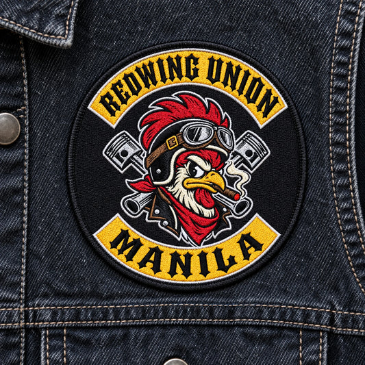 Round chest patch adapting the approved logo without adding dates or wording for a motorcycle club, shown at dark denim vest panel.