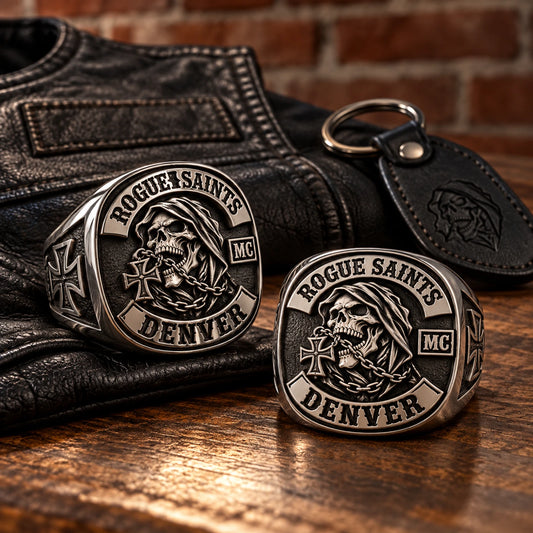 Matching stainless steel motorcycle club rings displayed with black leather clubhouse gear.