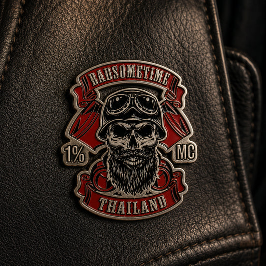 Antique silver motorcycle club identity pin displayed on a leather vest.