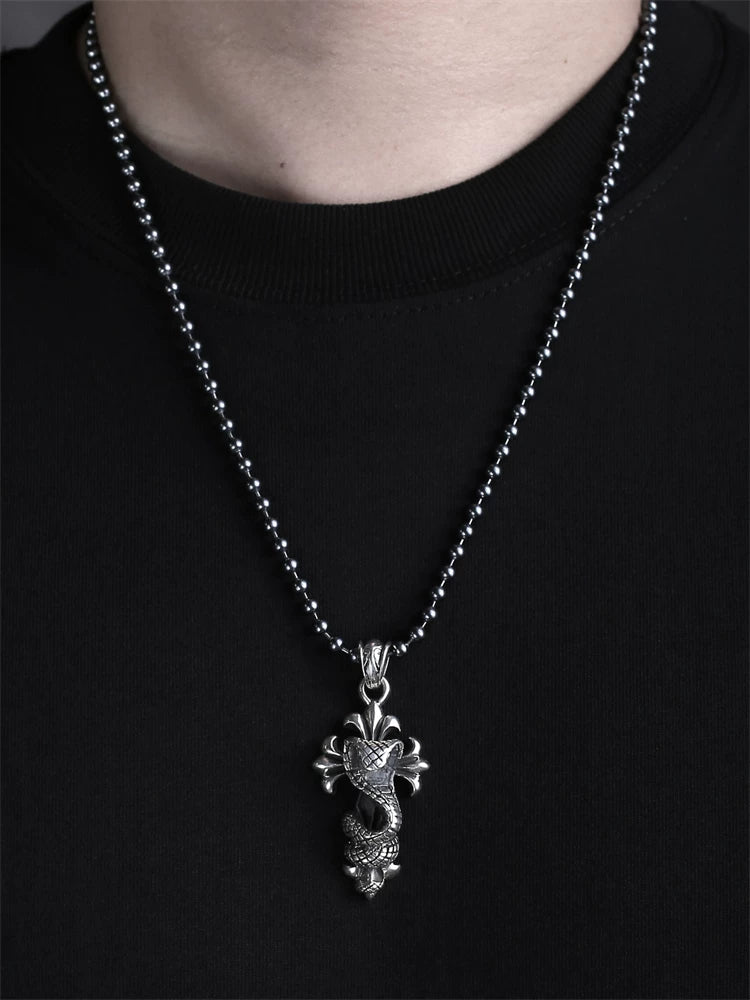 Cobra cross sterling silver pendant shown worn