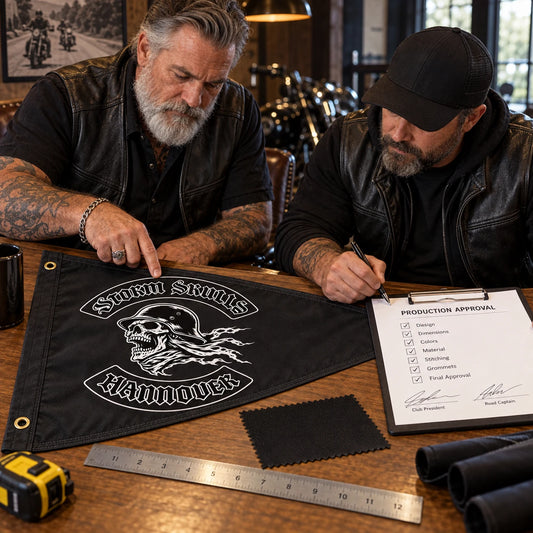 Two club officers confirm the artwork, dimensions and fabric for their custom triangle flag.