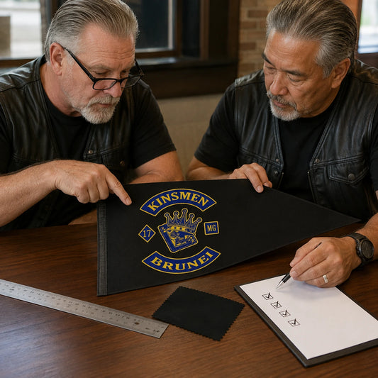 Two club officers confirm the artwork, dimensions and fabric for their custom triangle flag.