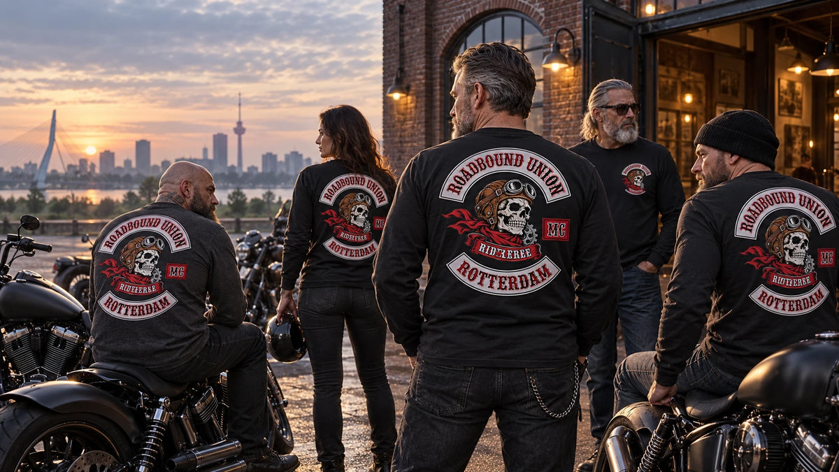 Mature motorcycle club riders wearing coordinated custom long-sleeve shirts outside a brick clubhouse.