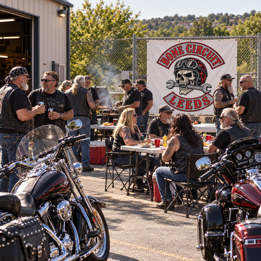 A motorcycle chapter meeting beneath a custom club identity banner in a garage.