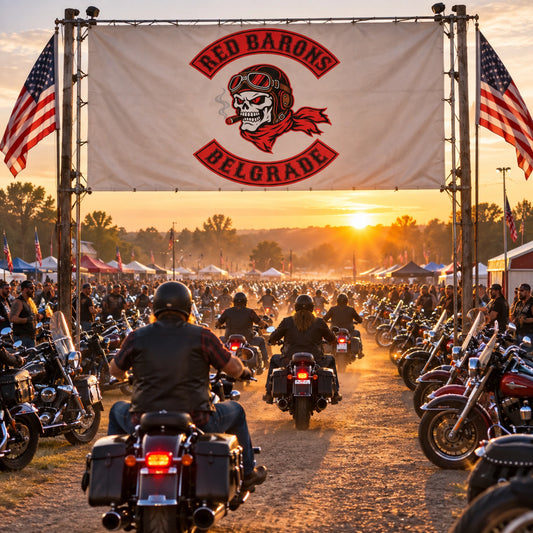 A custom motorcycle club banner displayed at a large open-air rider gathering.