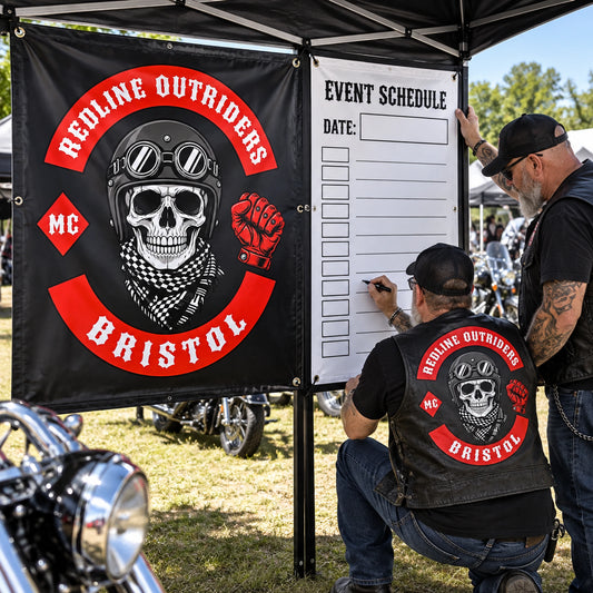 Rally organizers checking event details on a custom motorcycle club banner.
