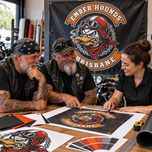 Club buyers comparing several custom event banner sizes with a production coordinator.