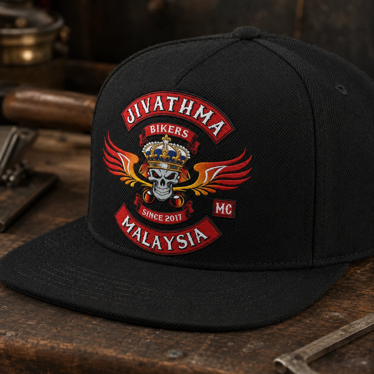 A black motorcycle club flat-brim cap close-up shows durable cotton twill weave and embroidery.