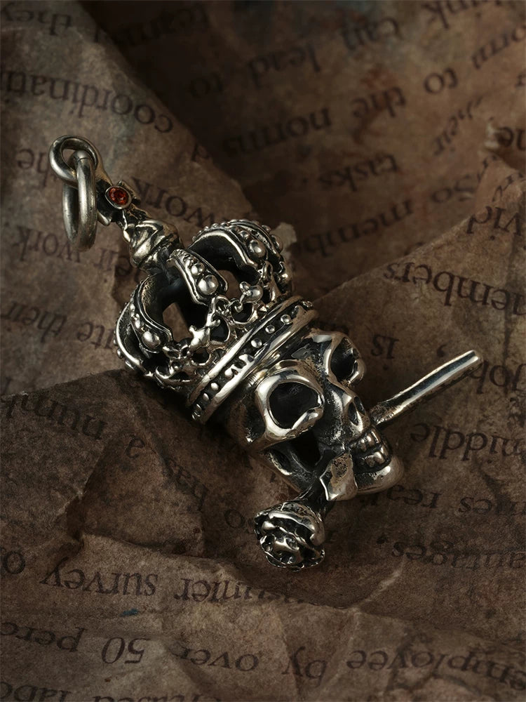 Angled view of crowned skull with rose silver pendant