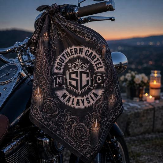 Custom motorcycle club bandana featuring the authorized Southern Cartel MC identity in quiet memorial ride overlook at blue hour, respectful commemorative bandana tied to a motorcycle handlebar.