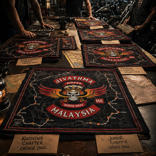 Custom motorcycle club bandana featuring the authorized Jivathma Motor Club identity in multiple chapter order packs arranged by destination on a long table, all using the same assigned club identity.