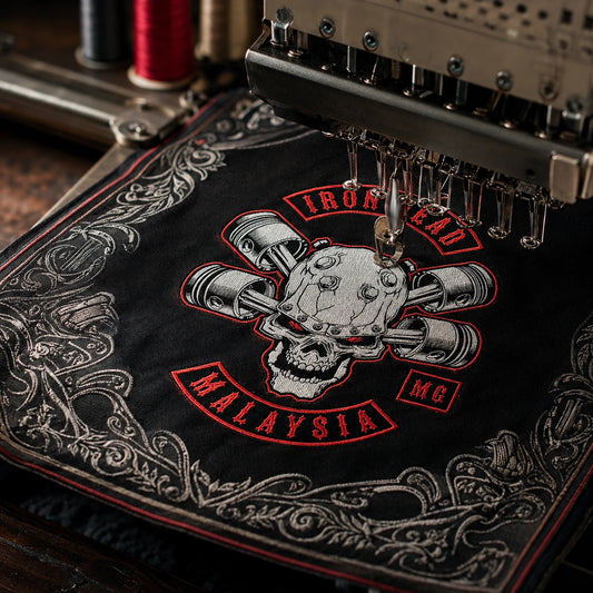 Custom motorcycle club bandana featuring the authorized Iron Head MG identity in embroidery machine stitching a compact club emblem into the corner of a heavy cotton bandana.