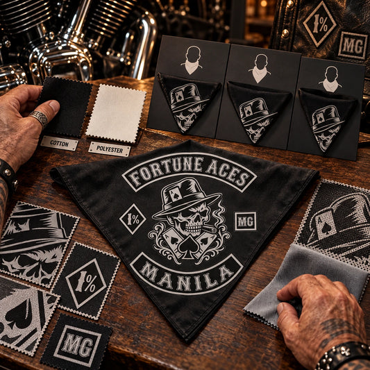 Hands choosing fabric, size and intended wearing style using a fold-aware layout with the authorized motorcycle club emblem kept visible in real use.