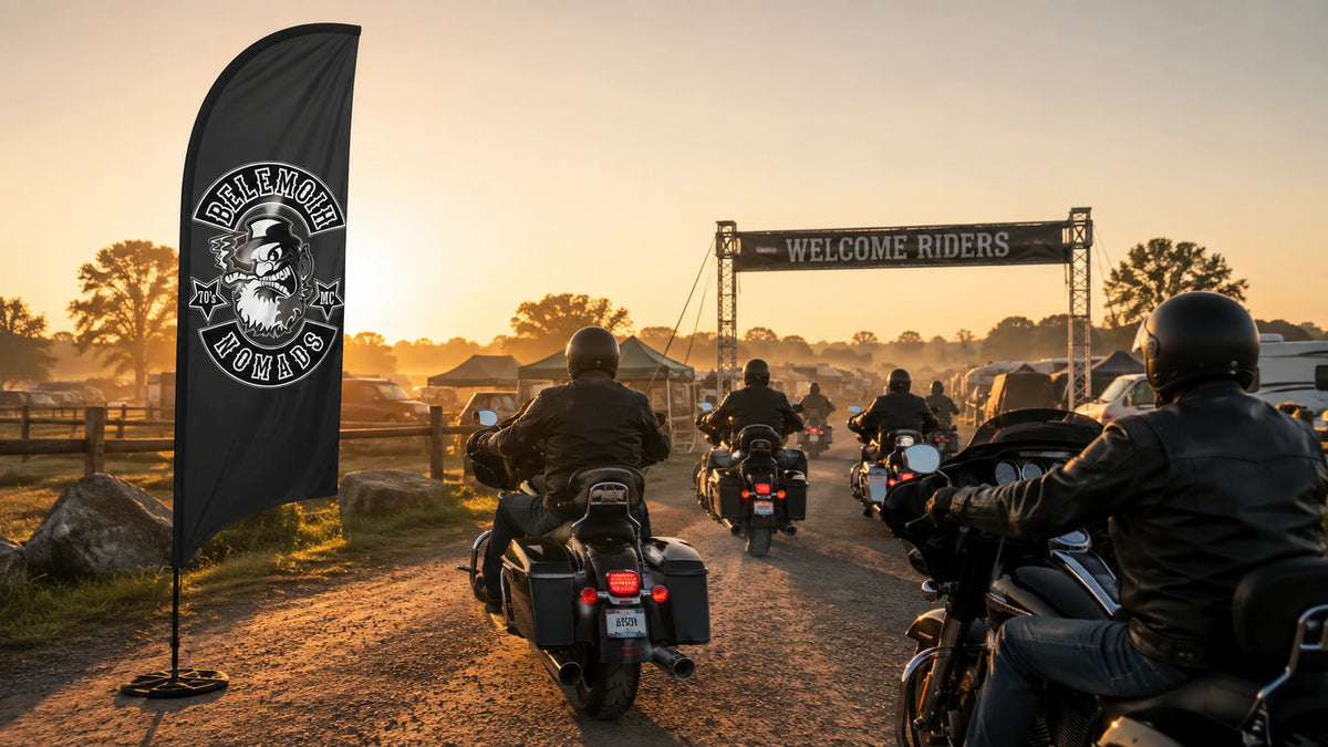Custom Feather Flags For Motorcycle Clubs: custom motorcycle club feather flag shown in five mature Harley-style touring riders arriving at a regional rally entrance at warm sunrise.