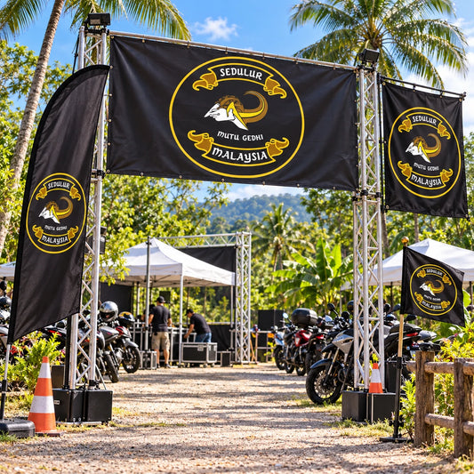 Custom motorcycle club flags and banners displaying an authorized club logo at a rally entrance.