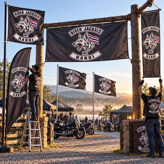 Custom motorcycle club flags and event banners displaying an approved club logo at a rally entrance.