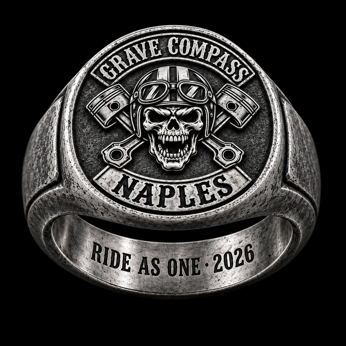 The same antique white copper Grave Compass motorcycle club ring tilted to show a short private inscription inside the band.