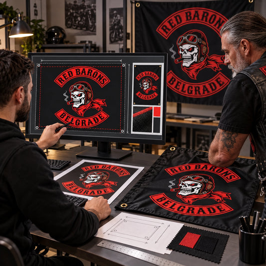 A professional designer builds a custom motorcycle club flag layout at a calibrated workstation.