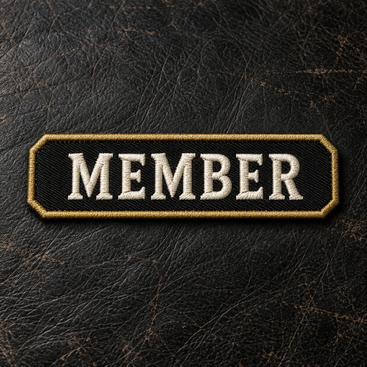 Custom-shaped short club-approved identifier bars arranged on a dark leather inspection surface, fully visible with realistic horizontal proportions, showing custom motorcycle club name bar patch options.