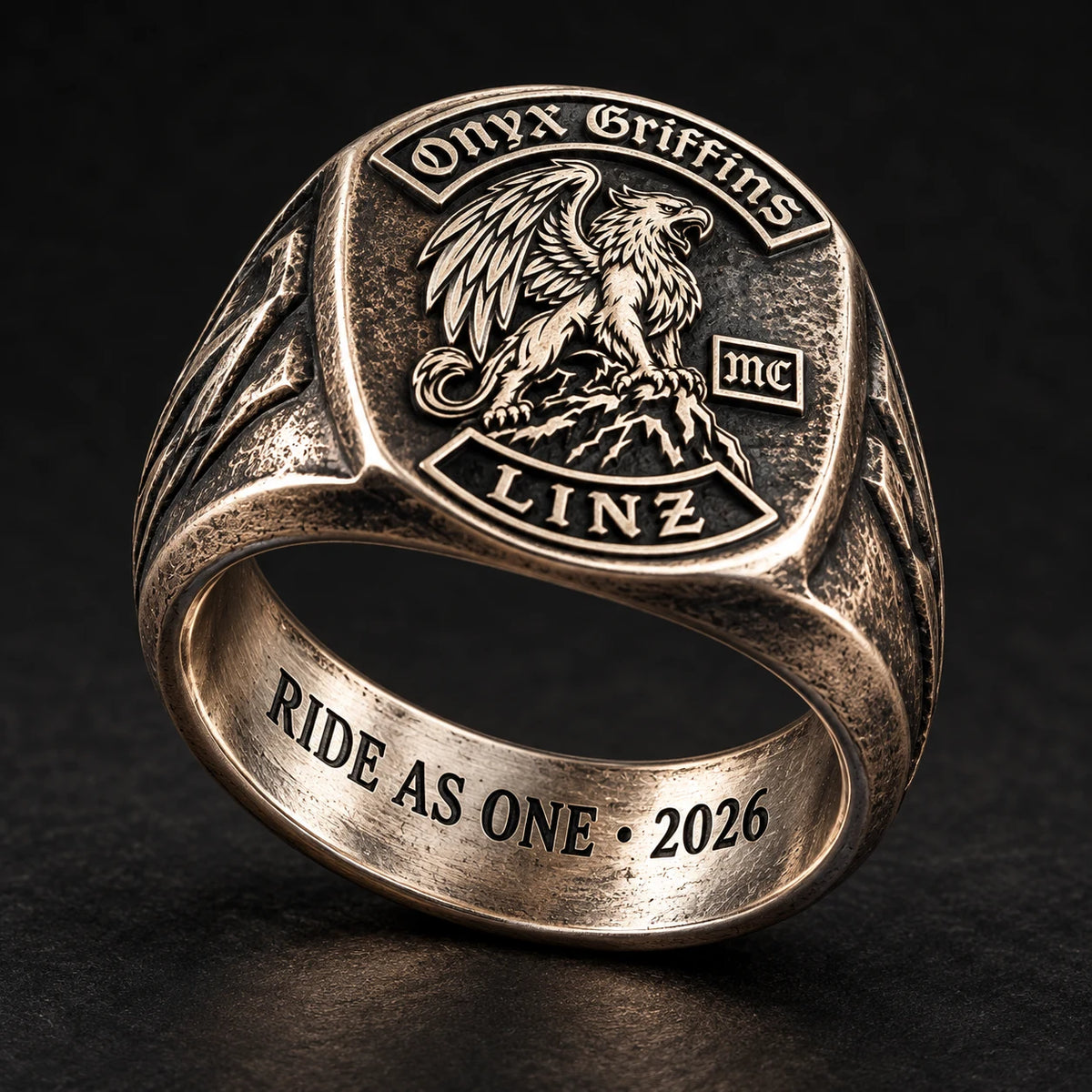 White copper Onyx Griffins motorcycle club ring tilted to show a short private inscription inside the band.