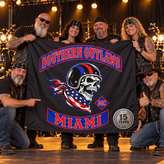 Motorcycle club members present a custom emblem flag on a warmly lit anniversary rally stage.